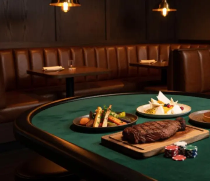 Australian bistro dishes served beside a poker table with cards and chips
